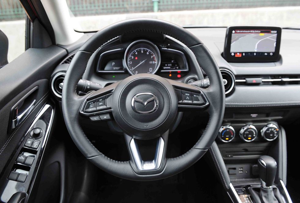 Land vehicle, Vehicle, Car, Steering wheel, Center console, Mazda, Steering part, Motor vehicle, Speedometer, Gear shift, 