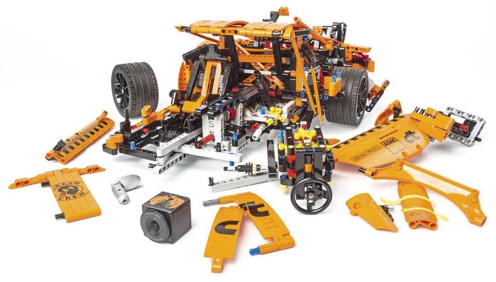 Automotive tire, Rim, Orange, Tread, Toy, Auto part, Space, Synthetic rubber, Construction set toy, Machine, 