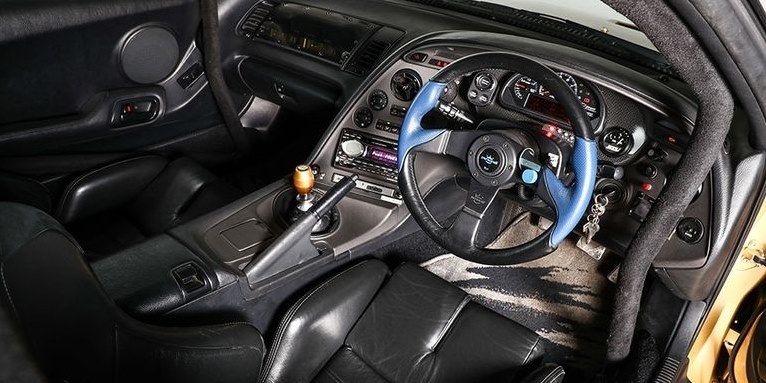 Land vehicle, Vehicle, Car, Steering wheel, Center console, Steering part, Gear shift, Sports car, Gauge, 