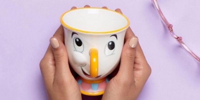 Finger, Yellow, Cup, Serveware, Orange, Nail, Toy, Fictional character, Thumb, Coffee cup, 