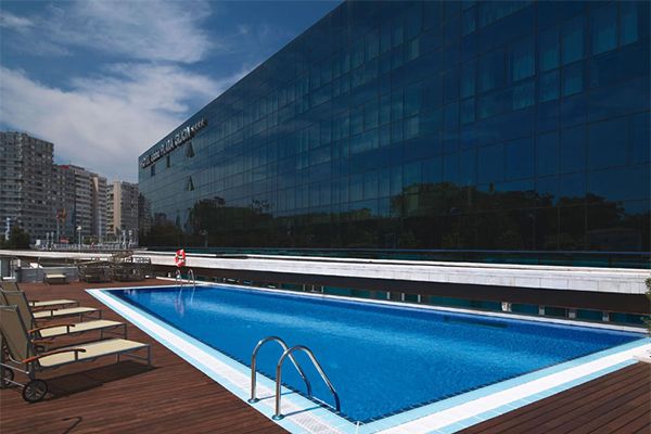 Swimming pool, Blue, Azure, Aqua, Rectangle, Composite material, Outdoor furniture, Apartment, Commercial building, Bench, 