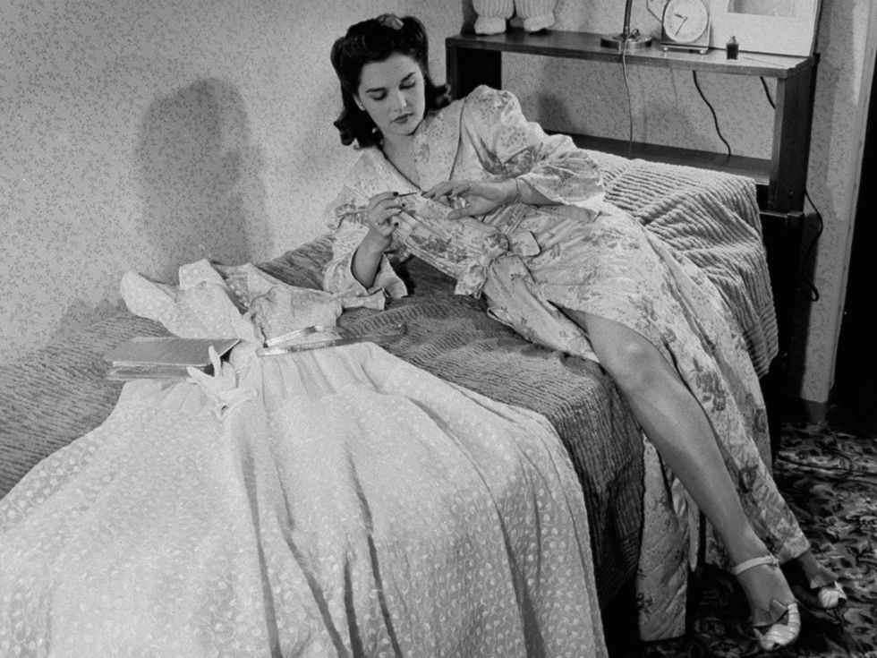 Human, Style, Sitting, Linens, Vintage clothing, Bed sheet, Monochrome, Bed, Gown, Bedroom, 