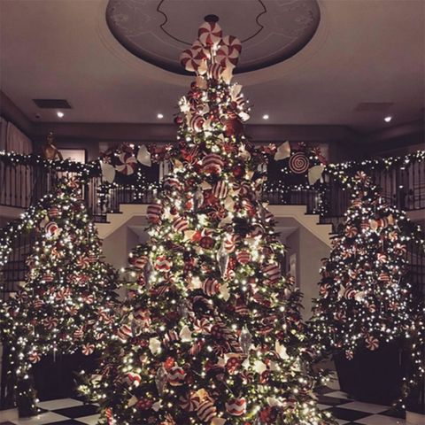 Lighting, Interior design, Event, Christmas decoration, Room, Property, Christmas tree, Red, Christmas ornament, Interior design, 
