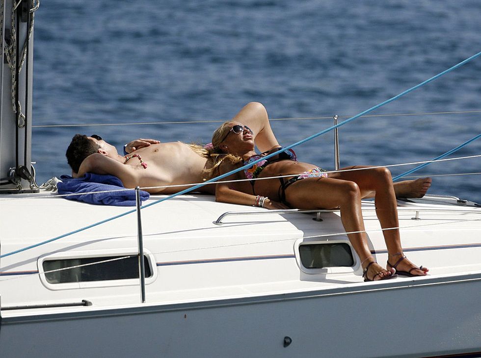 Sun tanning, Luxury yacht, Boat, Yacht, Vehicle, Bikini, Boating, Vacation, Muscle, Swimwear, 