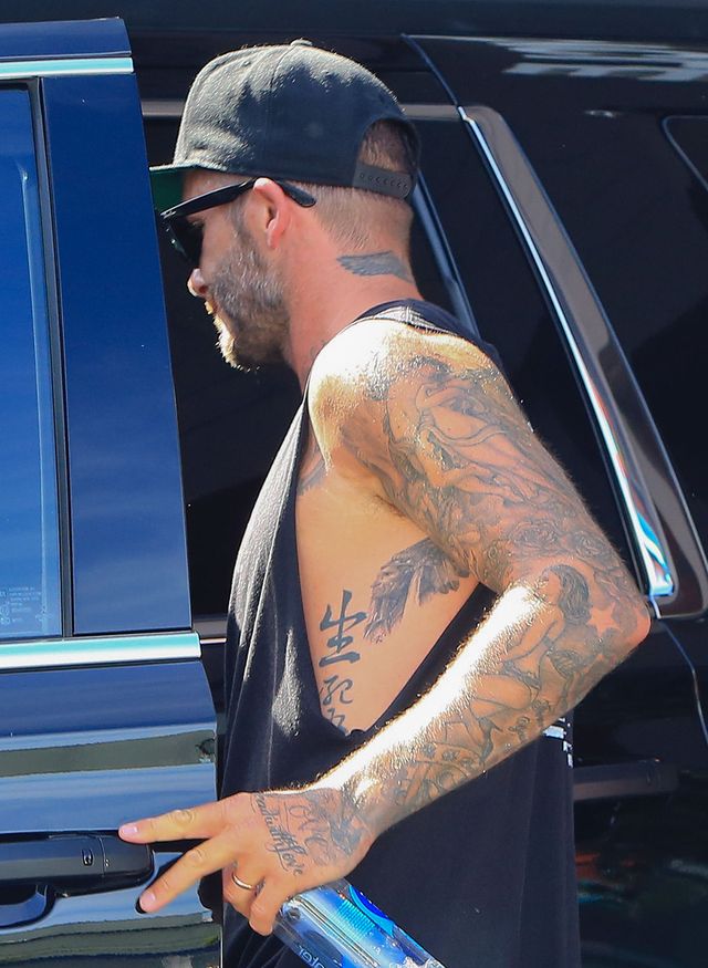 Tattoo, Barechested, Arm, Elbow, Muscle, Human body, Textile, Sunglasses, Back, Automotive window part, 
