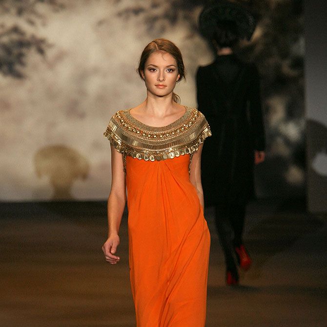 Shoulder, Formal wear, Style, Orange, Waist, Fashion model, Fashion, Fashion show, One-piece garment, Abdomen, 