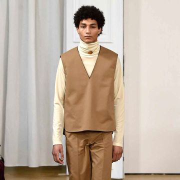 Brown, Sleeve, Trousers, Floor, Textile, Flooring, Collar, Outerwear, Fashion show, Style, 