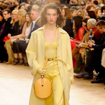 Fashion, Fashion show, Fashion model, Runway, Clothing, Yellow, Shoulder, Haute couture, Event, Outerwear, 