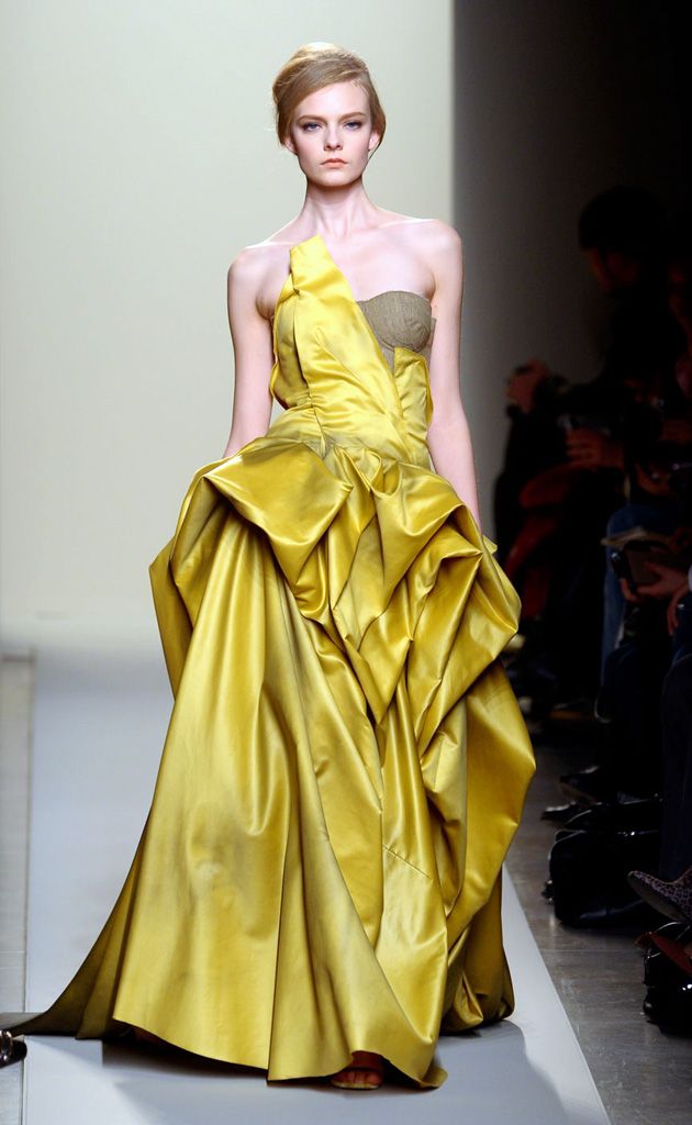 Clothing, Yellow, Hairstyle, Shoulder, Dress, Textile, Joint, Formal wear, Fashion model, One-piece garment, 