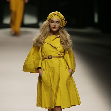 Yellow, Sleeve, Human leg, Joint, Dress, Fashion show, Fashion model, Street fashion, Runway, One-piece garment, 