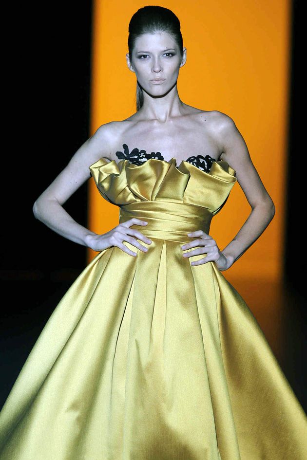 Clothing, Dress, Hairstyle, Yellow, Shoulder, Textile, Gown, Formal wear, Style, One-piece garment, 