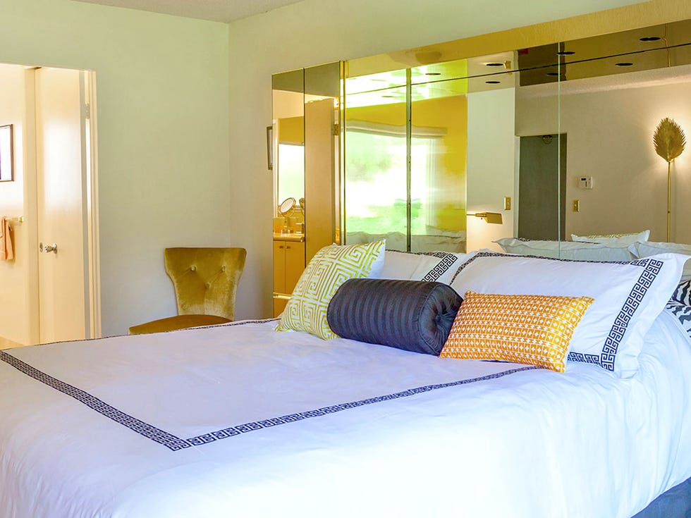 Bed, Lighting, Room, Yellow, Interior design, Bedding, Property, Bedroom, Floor, Textile, 