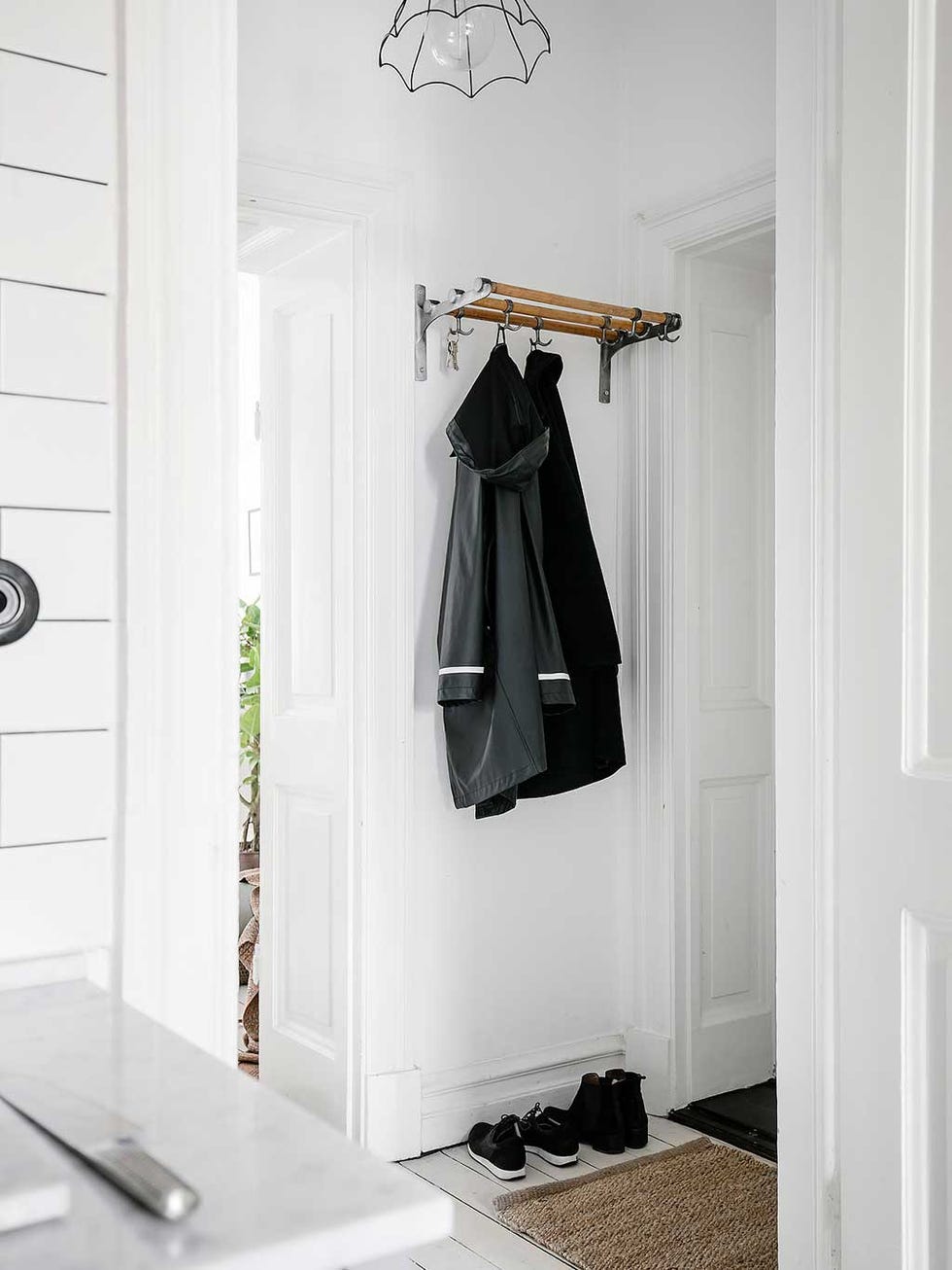 White, Clothes hanger, Room, Furniture, Wall, Interior design, Door, Floor, Shelf, Tile, 