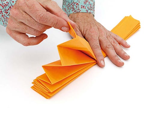 Finger, Yellow, Wrist, Nail, Orange, Paper product, Paper, Construction paper, Jewellery, Origami paper, 