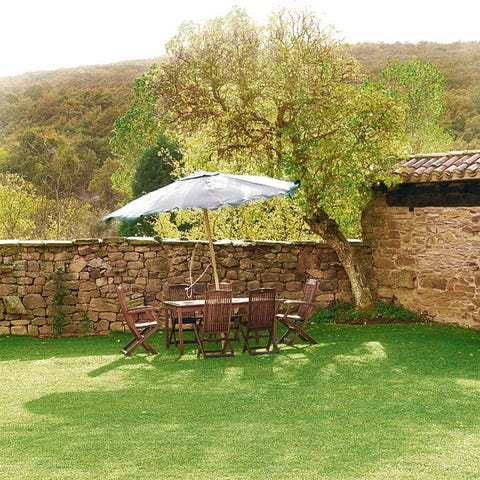 Umbrella, Outdoor table, Outdoor furniture, Bird, Stone wall, Lawn, Groundcover, Garden, Yard, Feather, 
