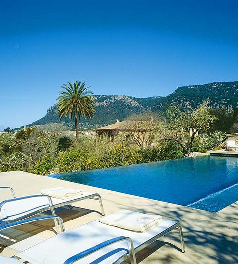 Resort, Swimming pool, Azure, Outdoor furniture, Sunlounger, Arecales, Resort town, Tropics, Seaside resort, Palm tree, 