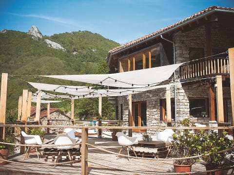Flowerpot, Outdoor furniture, Mountain range, Outdoor table, House, Home, Roof, Door, Shade, Patio, 