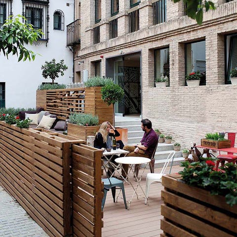 Window, Wood, Neighbourhood, Hardwood, Outdoor furniture, Flowerpot, Outdoor table, Brick, Courtyard, Armrest, 