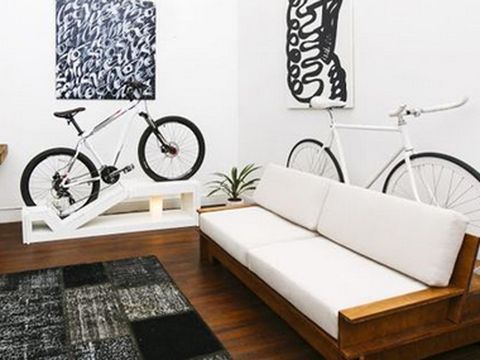mueble para bicicleta de paseo hecho a medida y hueco en el respaldo del sofá
