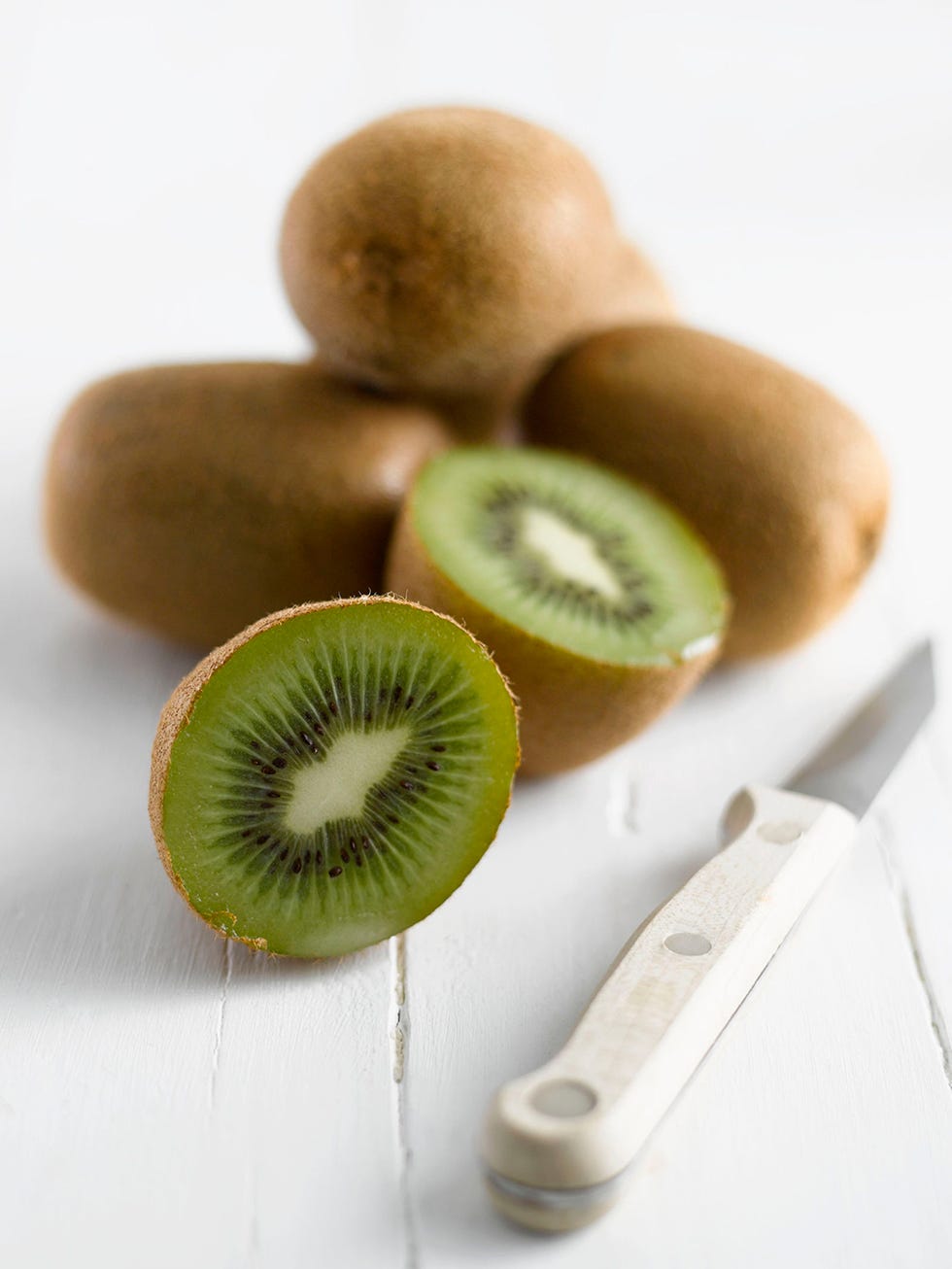 Hardy kiwi, Natural foods, Fruit, Vegan nutrition, Kitchen utensil, Ingredient, Produce, Whole food, Knife, Still life photography, 