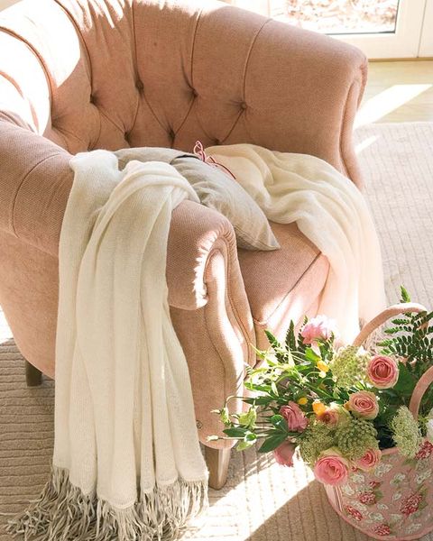 Petal, Couch, Living room, Bouquet, Cut flowers, Peach, Artificial flower, Tan, Flower Arranging, Interior design, 