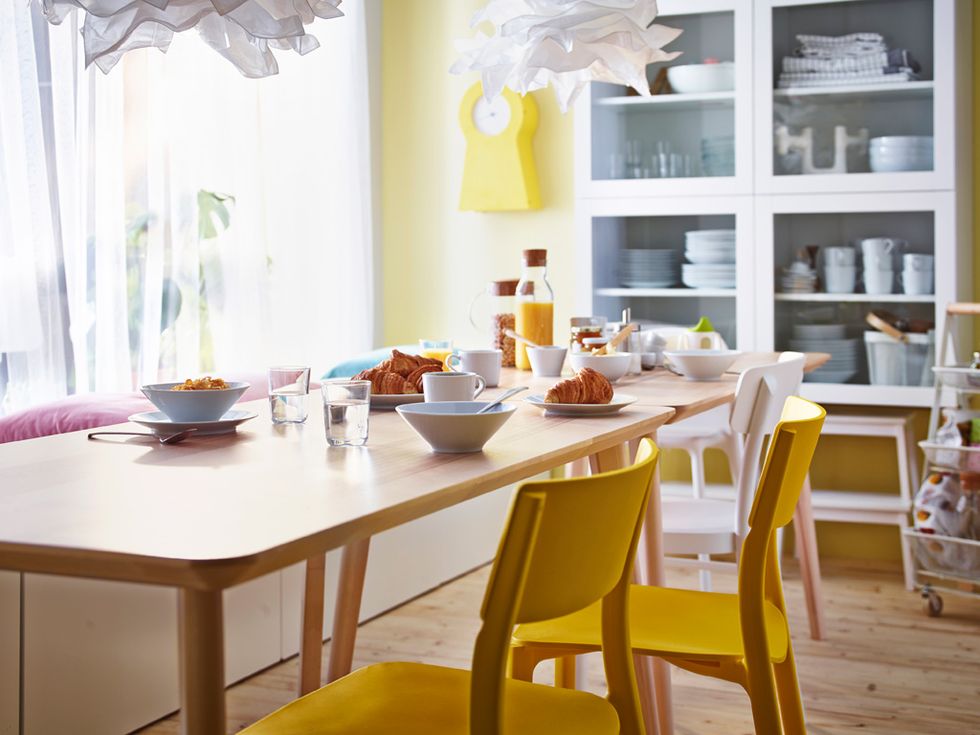 wooden dining room with yellow chairs