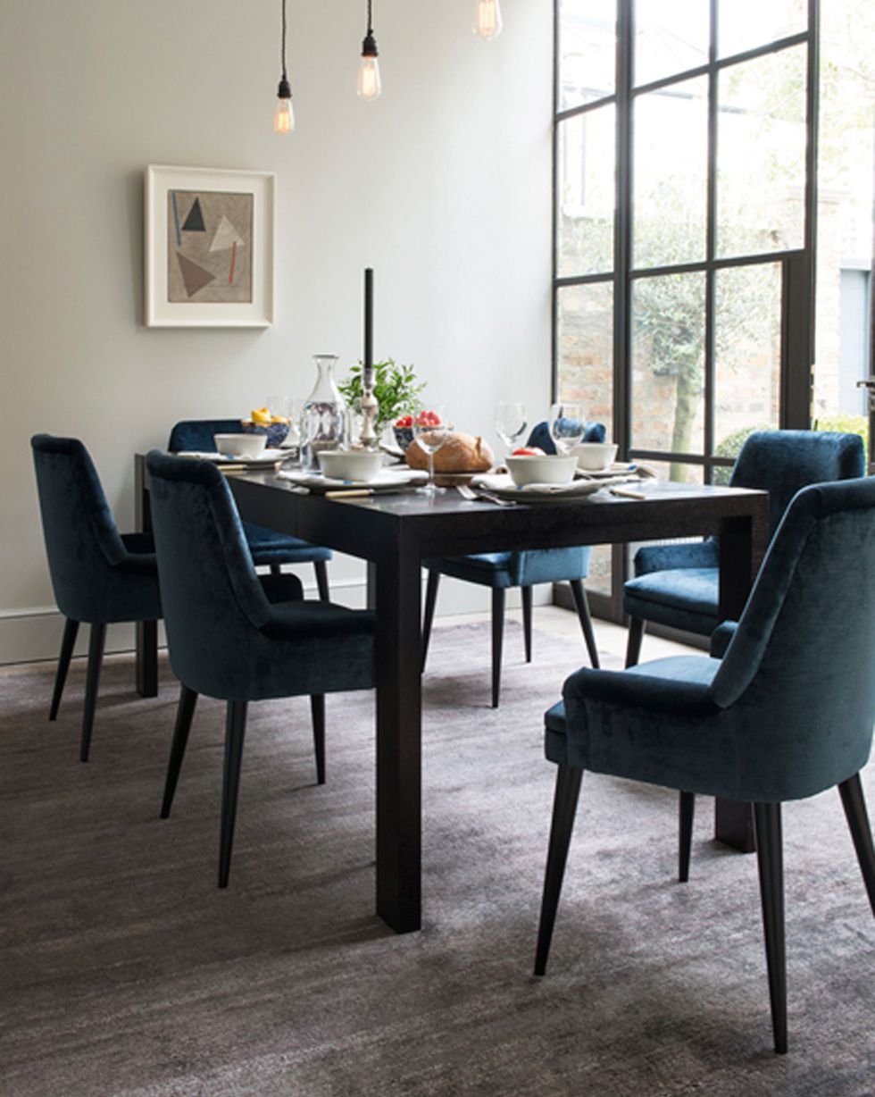 dining room with blue upholstered chairs