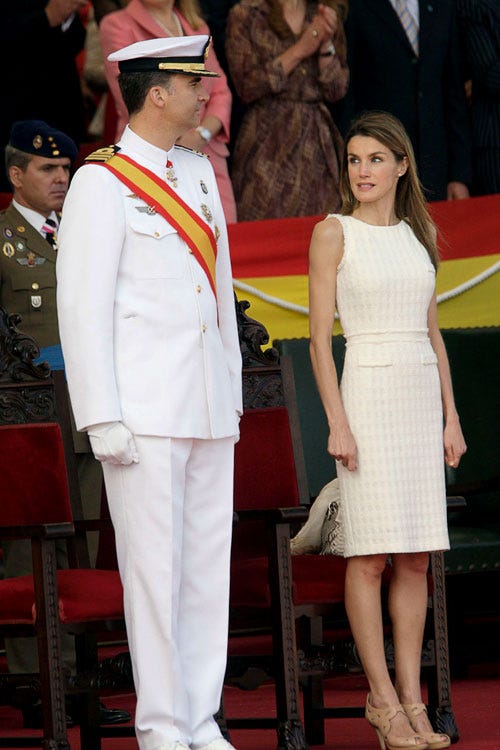 Dress, Trousers, Hat, Formal wear, Suit trousers, Uniform, Cap, Fashion, One-piece garment, Carpet, 