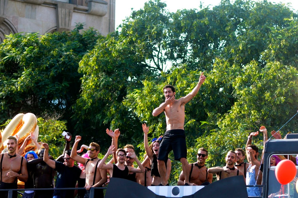 Entertainment, Barechested, Muscle, Chest, Public event, Trunk, Active shorts, Performance art, Trunks, Sun hat, 