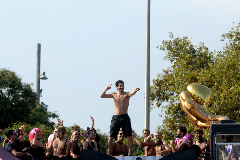 Crowd, Barechested, Audience, Public event, Pole, Block party, Festival, Loudspeaker, Trunks, 