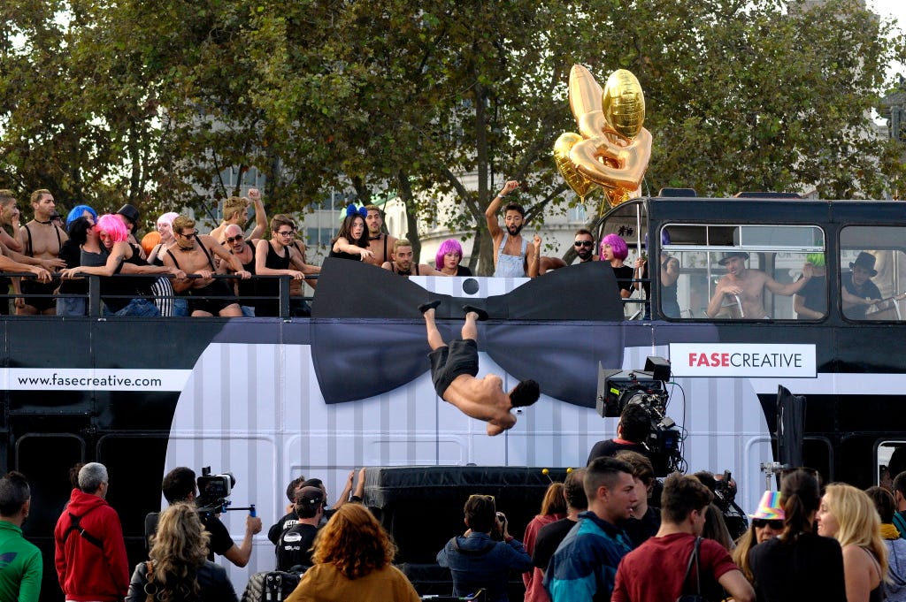 Arm, Crowd, Street performance, Public event, Audience, Dance, Acrobatics, Sun hat, Dancer, Block party, 