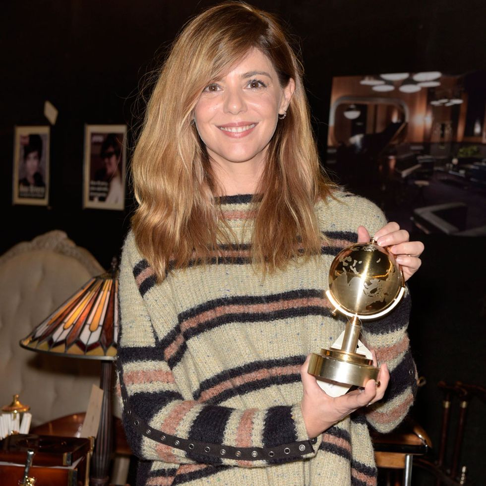 Sweater, Trophy, Blond, Brown hair, Picture frame, Shelving, Tights, Long hair, Award, Shelf, 