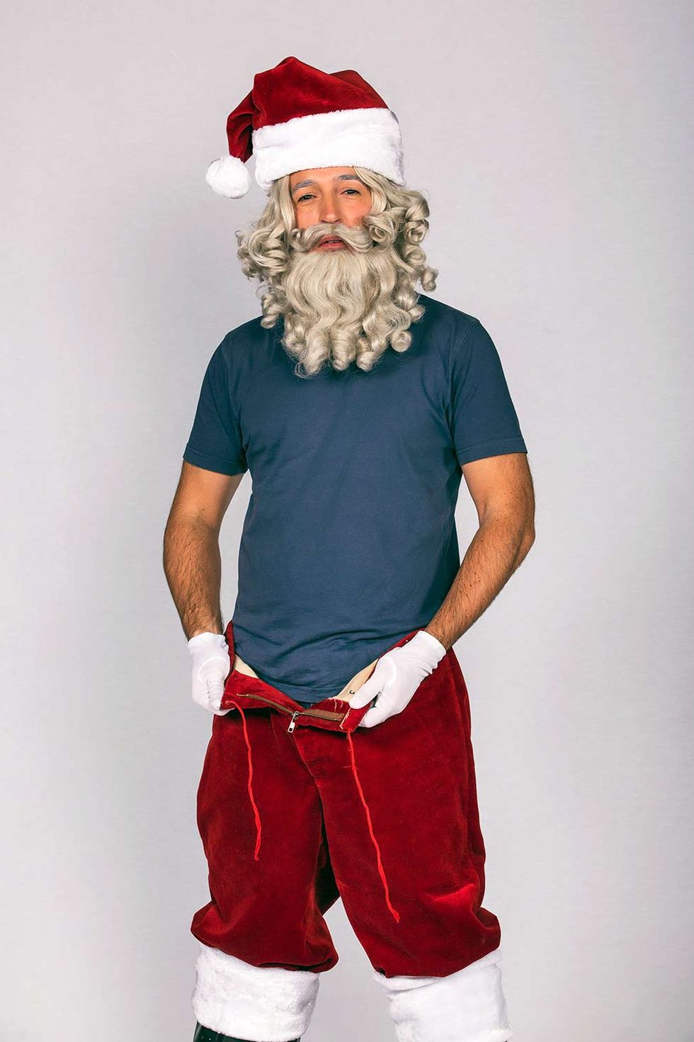 Santa claus, Red, Facial hair, Christmas, Beard, Standing, Fictional character, Muscle, Costume, Sleeve, 