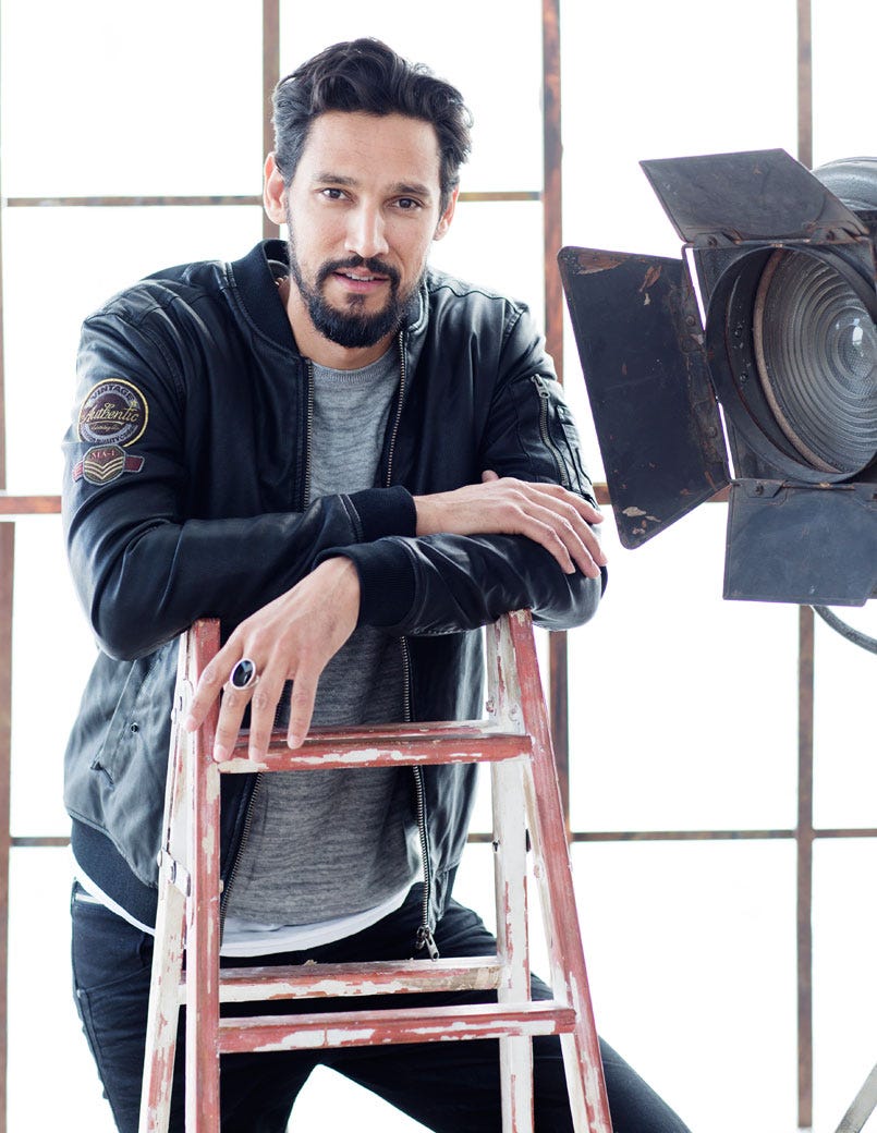 Facial hair, Audio equipment, Beard, Moustache, Sitting, Public address system, Loudspeaker, Stool, Camera accessory, Optical instrument, 