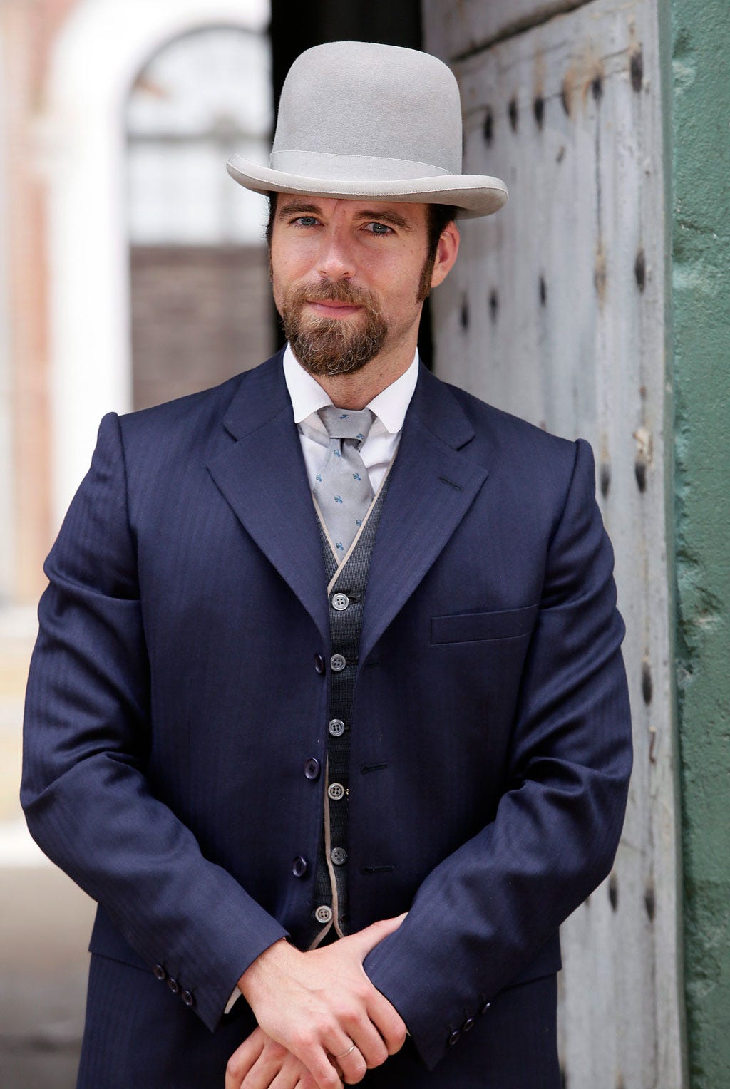 Clothing, Coat, Hat, Facial hair, Dress shirt, Collar, Sleeve, Shirt, Outerwear, Suit, 
