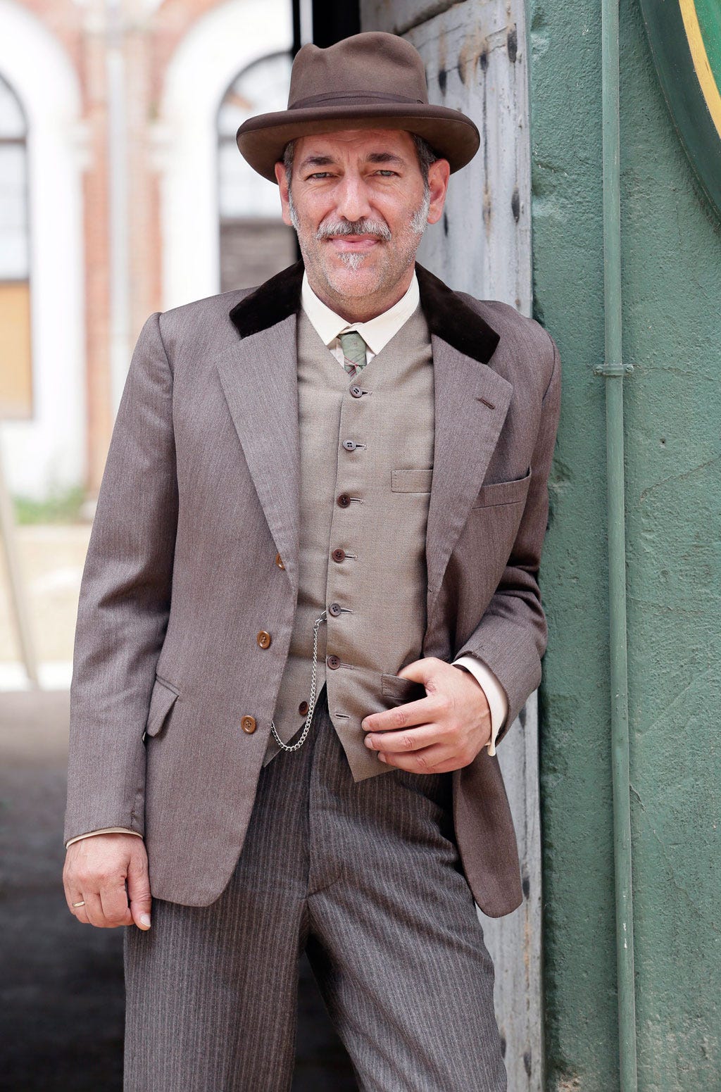 Clothing, Hat, Dress shirt, Collar, Coat, Trousers, Shirt, Suit trousers, Standing, Outerwear, 