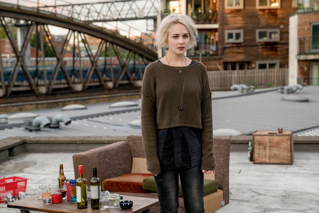 Clothing, Human body, Denim, Jeans, Bottle, Street fashion, Drink, Glass bottle, Bridge, Beige, 