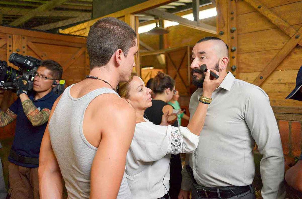 Hair, Social group, Community, Sleeveless shirt, Chest, Camera, Abdomen, Vest, Tradition, Ceremony, 