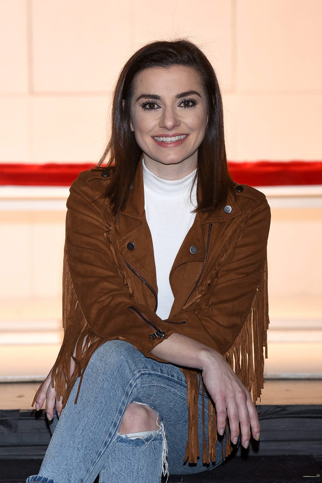 Clothing, Hairstyle, Denim, Jeans, Textile, Sitting, Jacket, Outerwear, Bag, Long hair, 