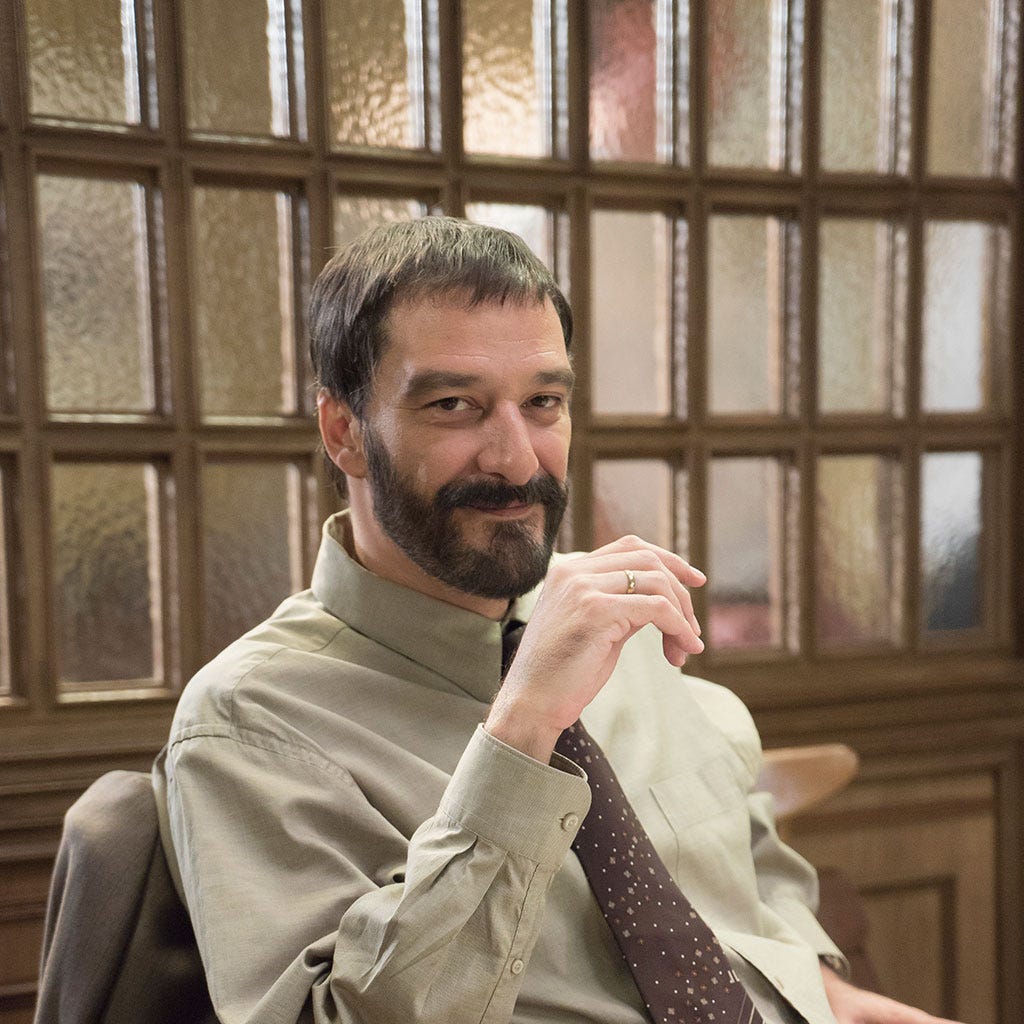 Facial hair, Dress shirt, Beard, Sitting, Moustache, Publication, Book, White-collar worker, Reading, Coffee cup, Facial hair, Dress shirt, Beard, Sitting, Moustache, Publication, Book, White-collar worker, Reading, Coffee cup,