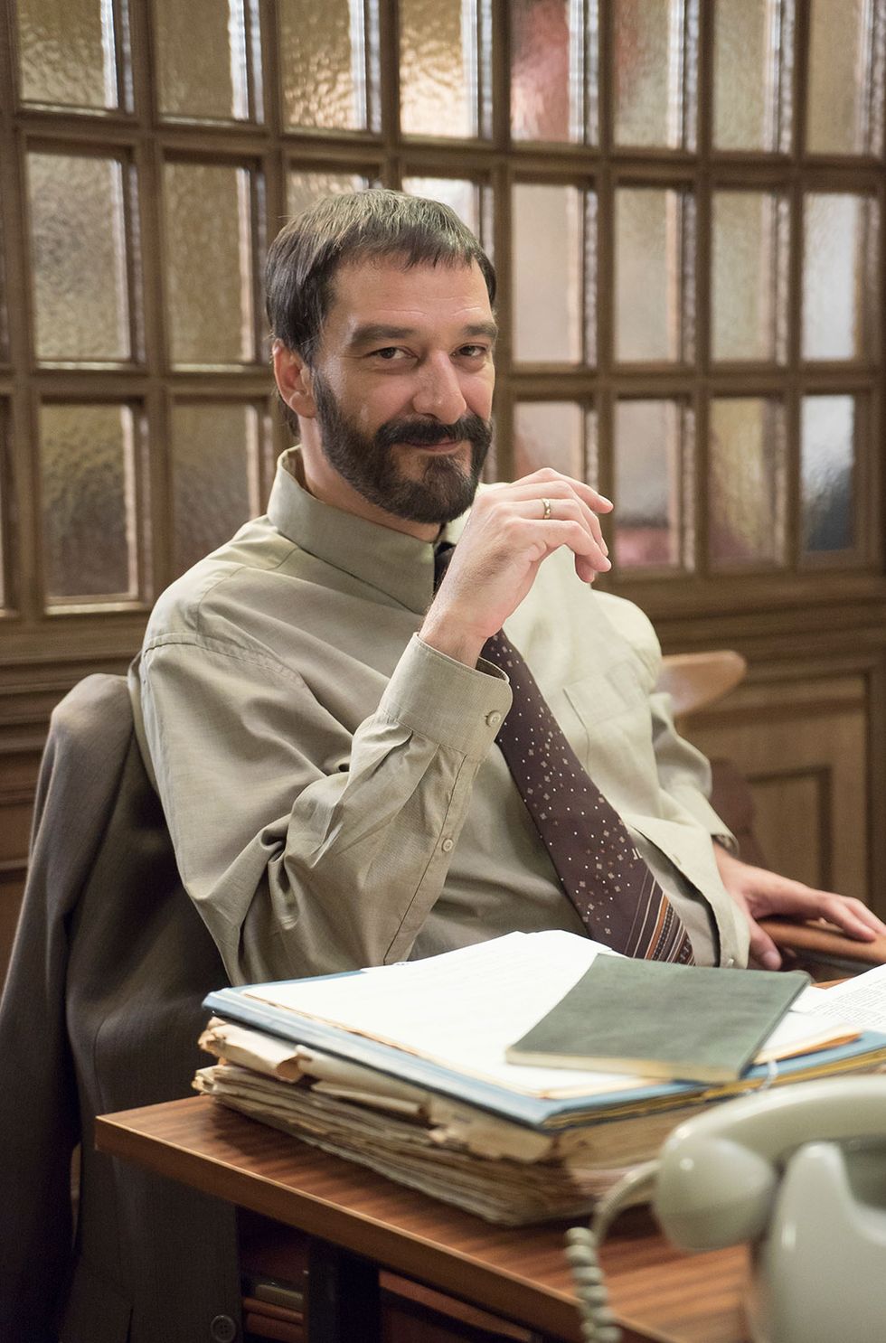 Facial hair, Dress shirt, Beard, Sitting, Moustache, Publication, Book, White-collar worker, Reading, Coffee cup, 