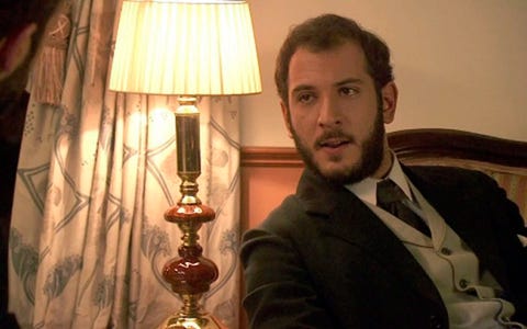 Lighting, Lampshade, Coat, Facial hair, Collar, Suit, Outerwear, Formal wear, Lamp, Lighting accessory, 