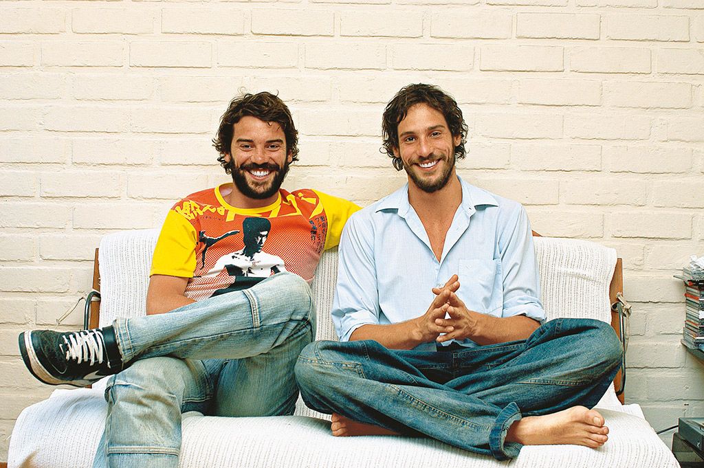 Leg, Smile, Facial hair, Sitting, Shoe, Jeans, Denim, Beard, T-shirt, Moustache, 