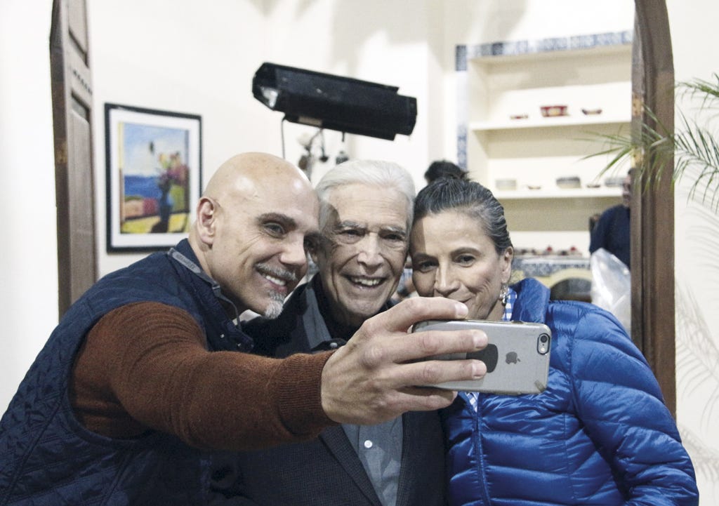Ear, Smile, Tooth, Sweater, Picture frame, Camera, Love, Wrinkle, Laugh, Cameras & optics, 