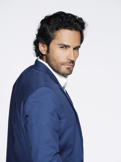 Clothing, Facial hair, Dress shirt, Hairstyle, Collar, Sleeve, Shoulder, Coat, Standing, Formal wear, 
