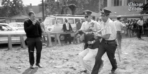 a young Bernie Sanders is arrested by two police officers during a Civil Rights protest