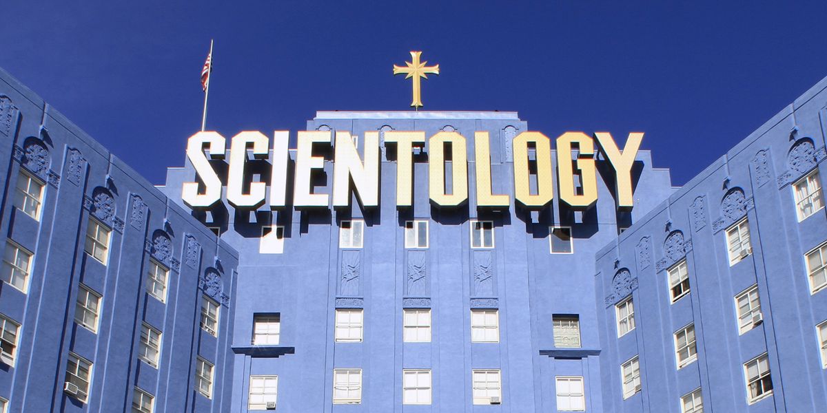 blue building with a large sign that reads "Scientology"
