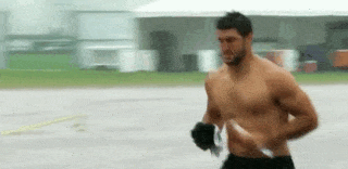 an animated gif of Tim Tebow running without a shirt on