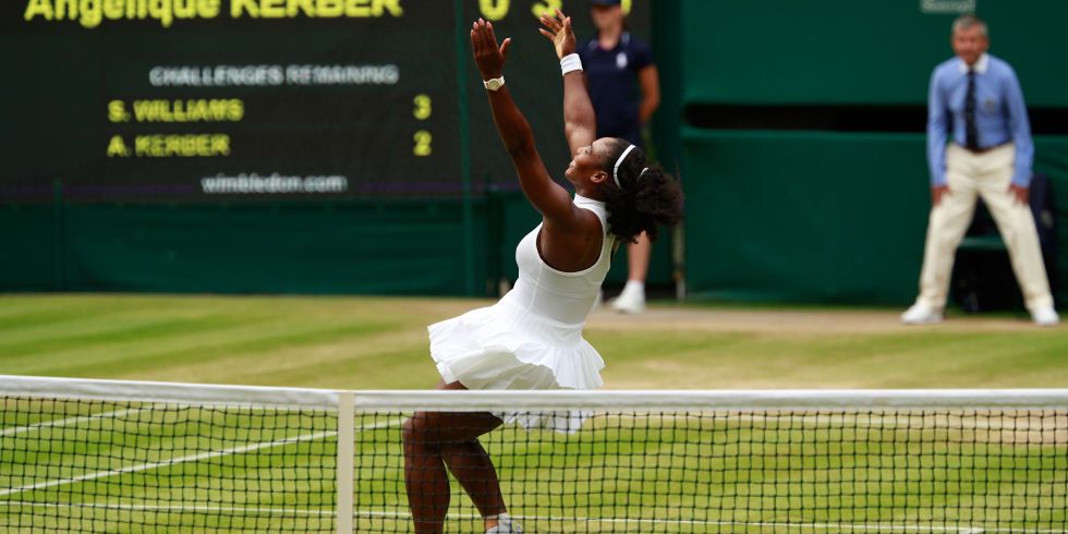 Serena Williams raises her hands in the air on Wimbledon's center court
