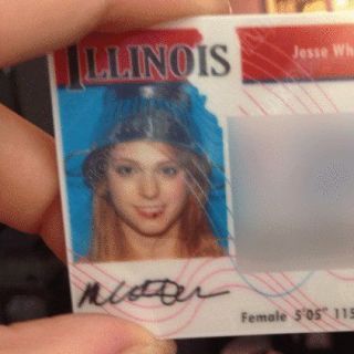 a drivers license with a photo of a woman wearing a steel colander on her head